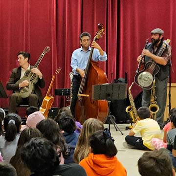 3 piece band performing on stage