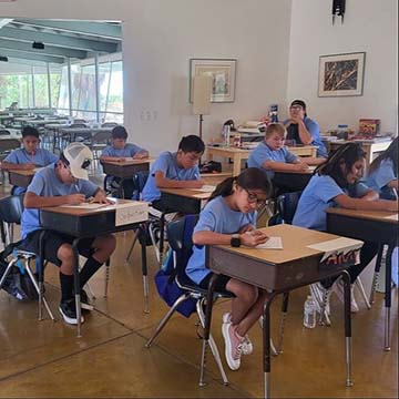 Children sitting at desks in classroom